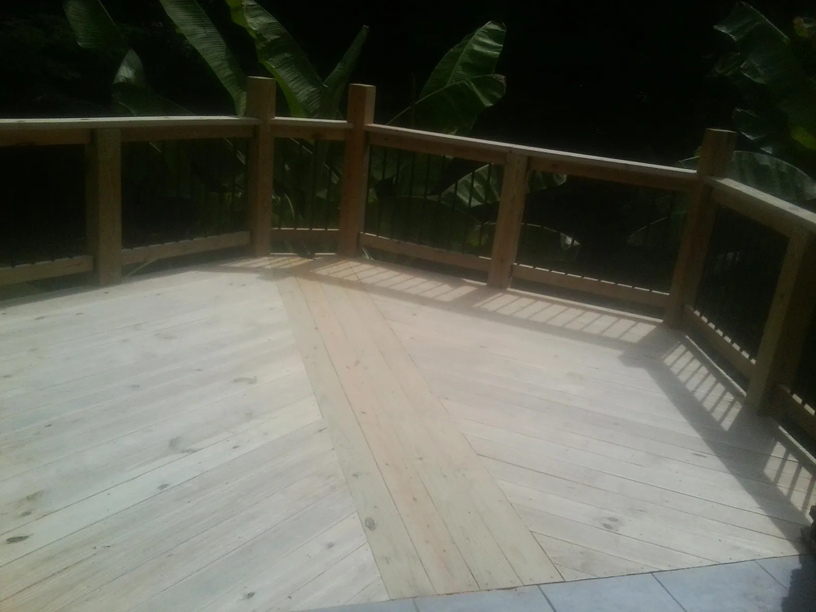 New wood deck and railing built off the back of a home in Riceville